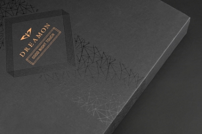 Spot UV highlights small design elements on corrugated cardboard.
